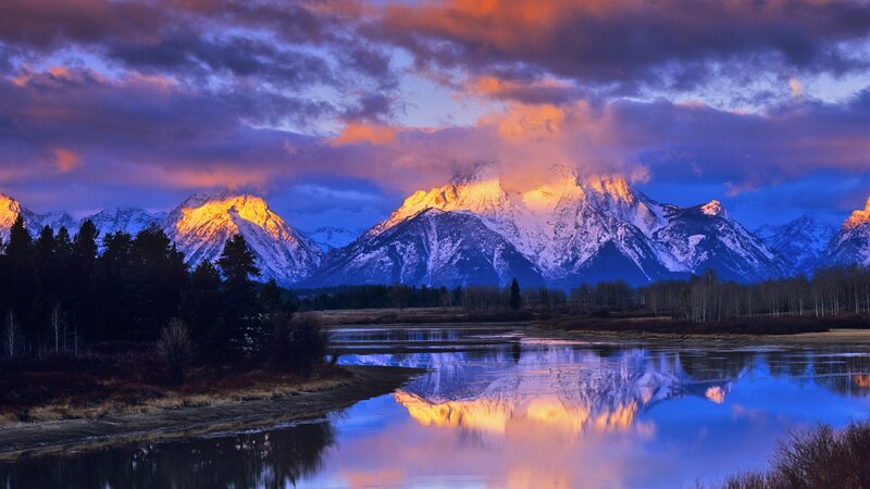 mountain sunset with river reflection