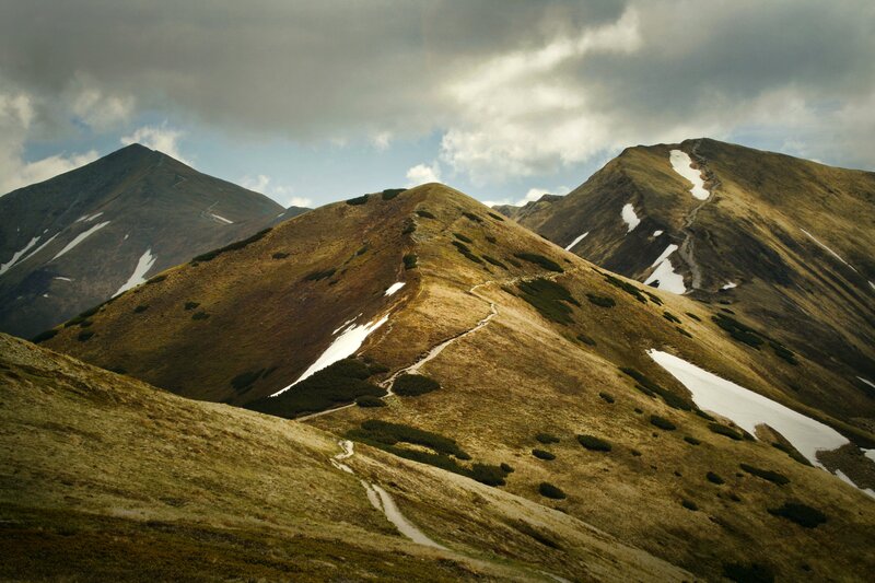 Mountain trail under cloudy sky