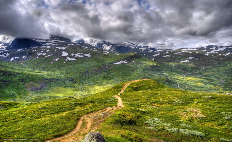 Mountain trail under cloudy sky