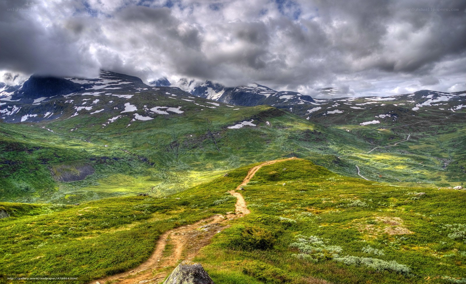 Mountain trail under cloudy sky