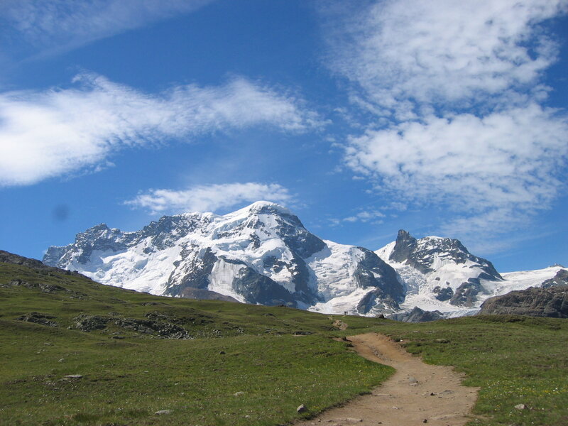 Mountain trail with snow-capped peaks