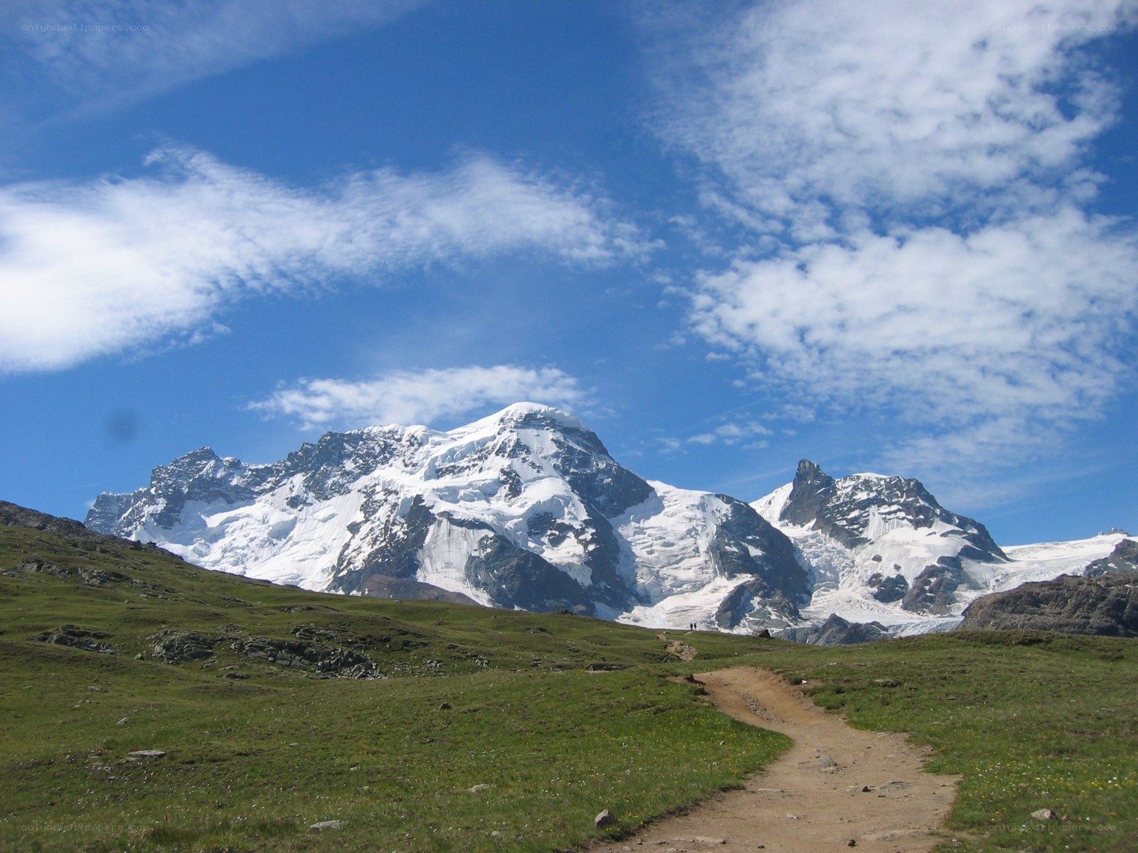 Mountain trail with snow-capped peaks