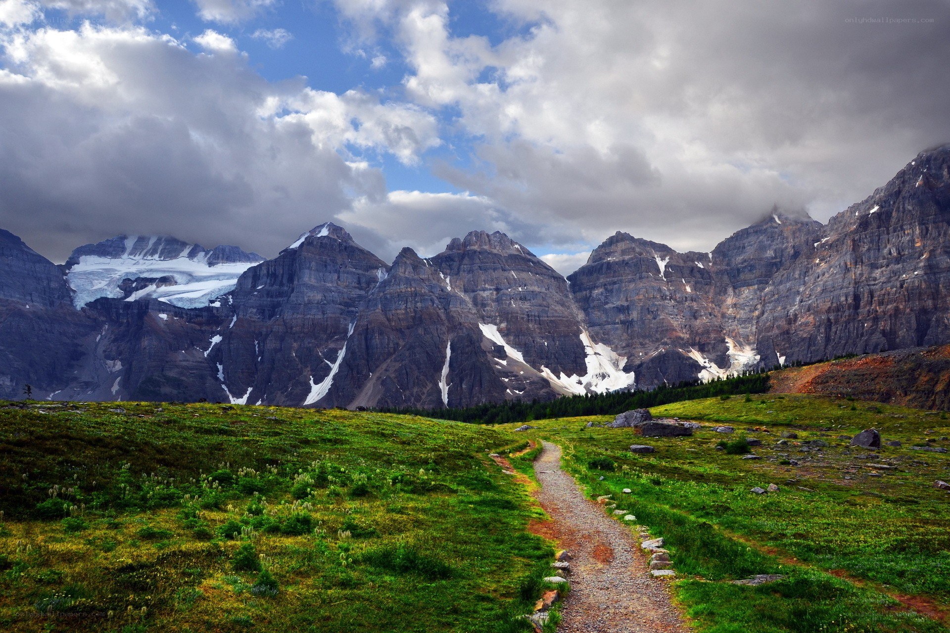 Mountain trail with snow-capped peaks