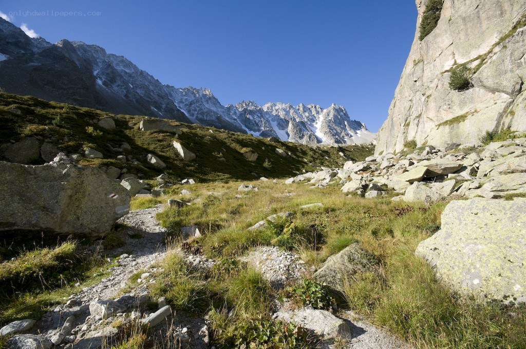 Mountain trail with snow-capped peaks
