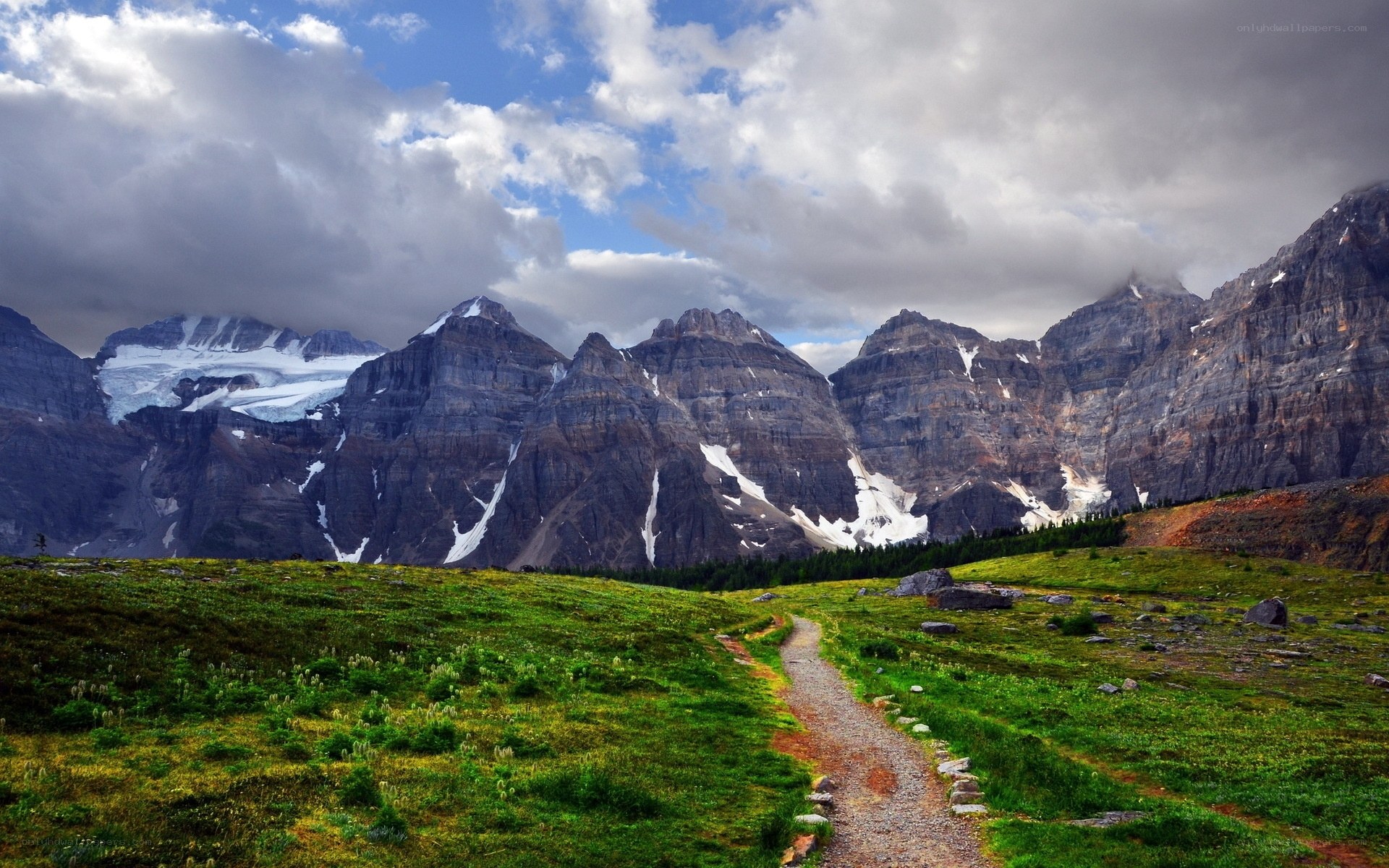 Mountain trail with snow-capped peaks
