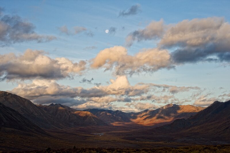 Mountain valley at dusk with moon