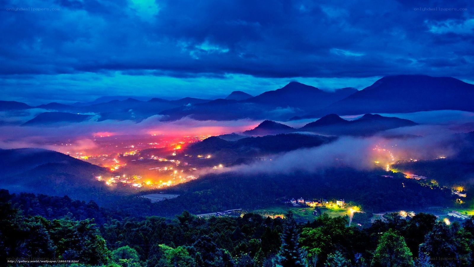 Mountain valley at night with fog