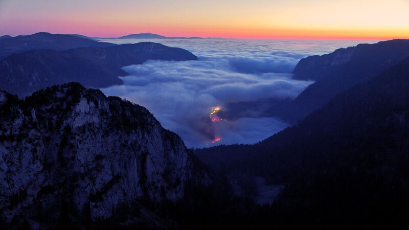 Mountain valley at sunset with clouds