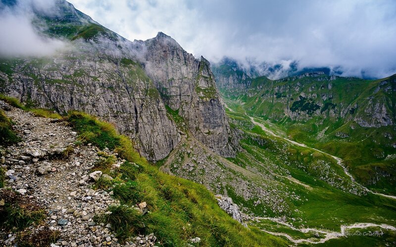 Mountain Valley Landscape — Green, Dramatic, Photograph, Mountains, Clouds, Gravel Path