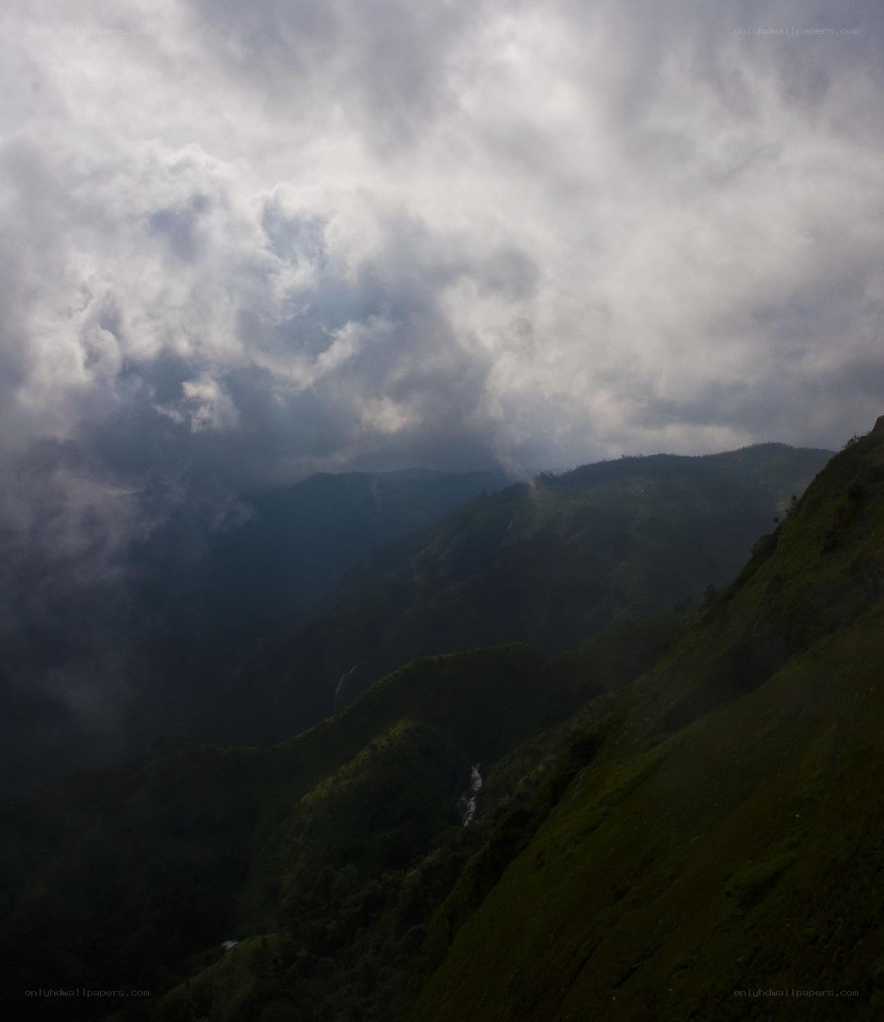 Mountain valley under cloudy sky