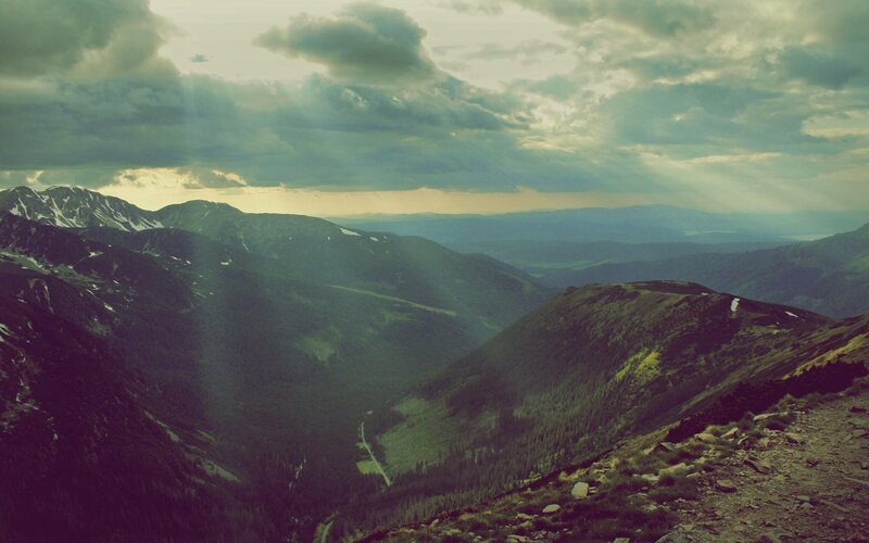 mountain valley under cloudy sky