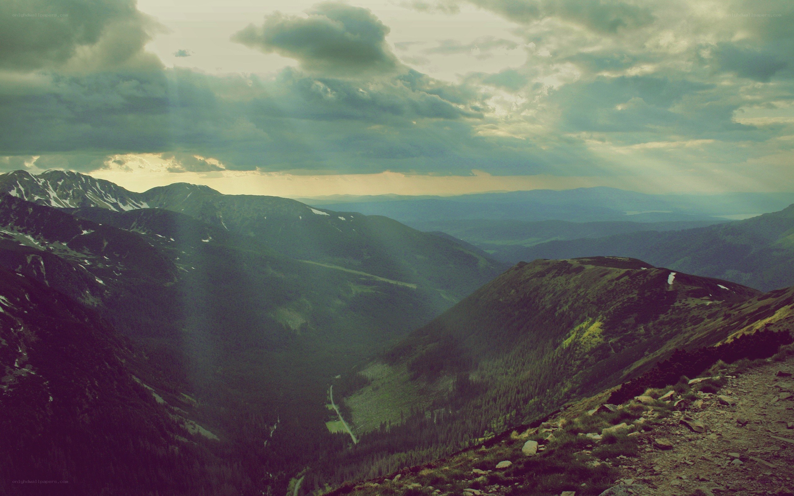 mountain valley under cloudy sky