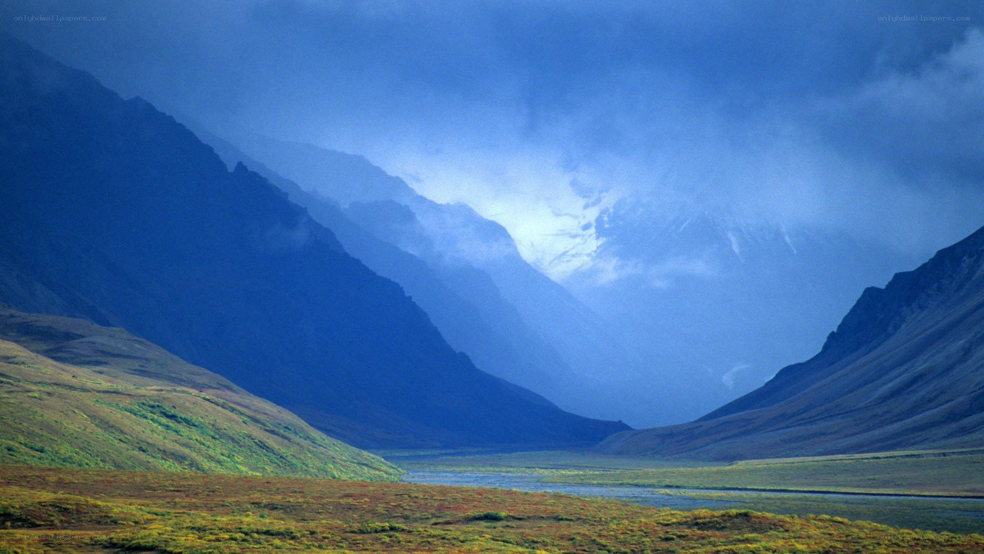 mountain valley under cloudy sky