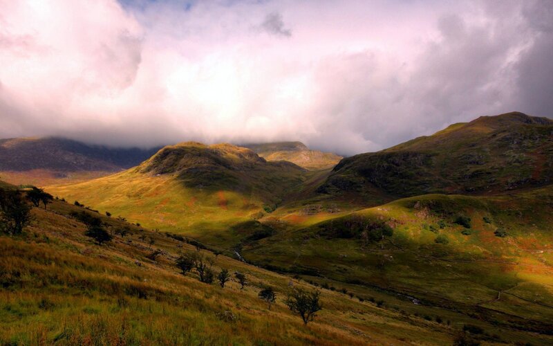 Mountain valley under cloudy sky