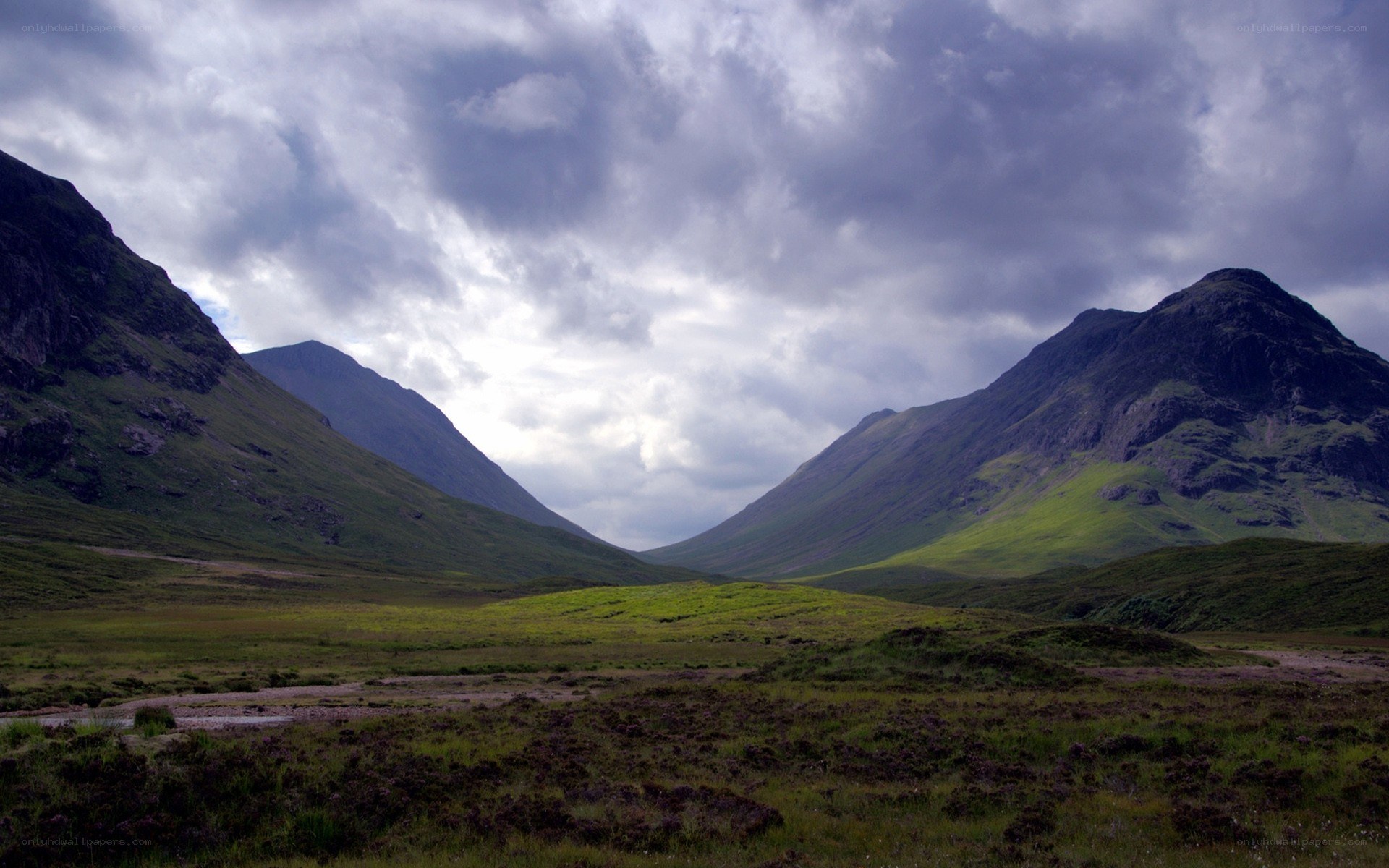 Mountain valley under cloudy sky