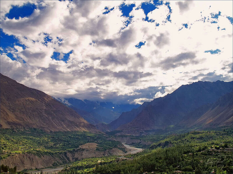 Mountain valley under cloudy sky