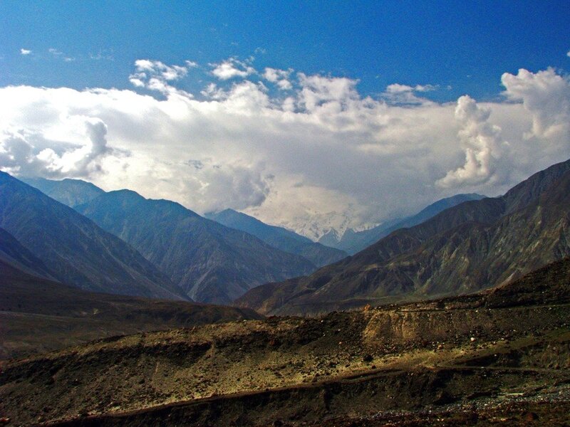 mountain valley under cloudy sky