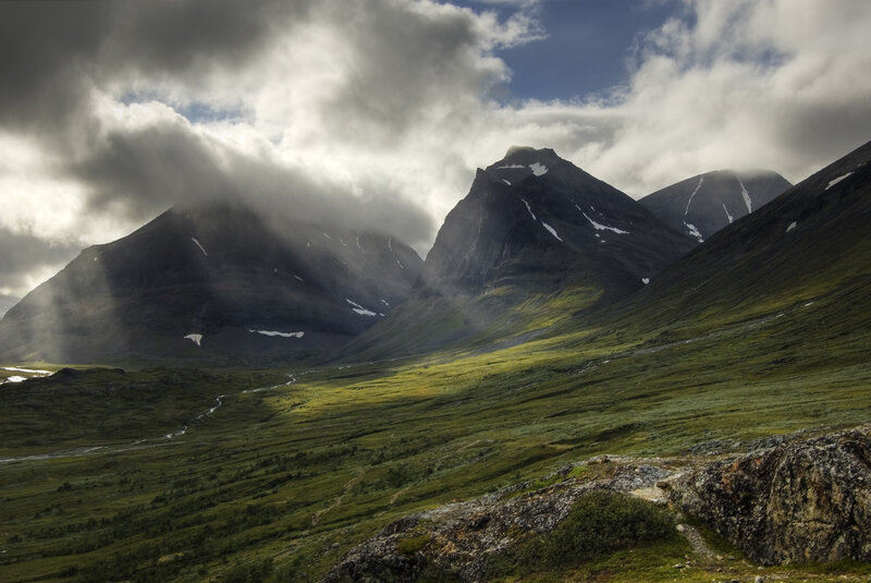 Mountain valley under cloudy sky