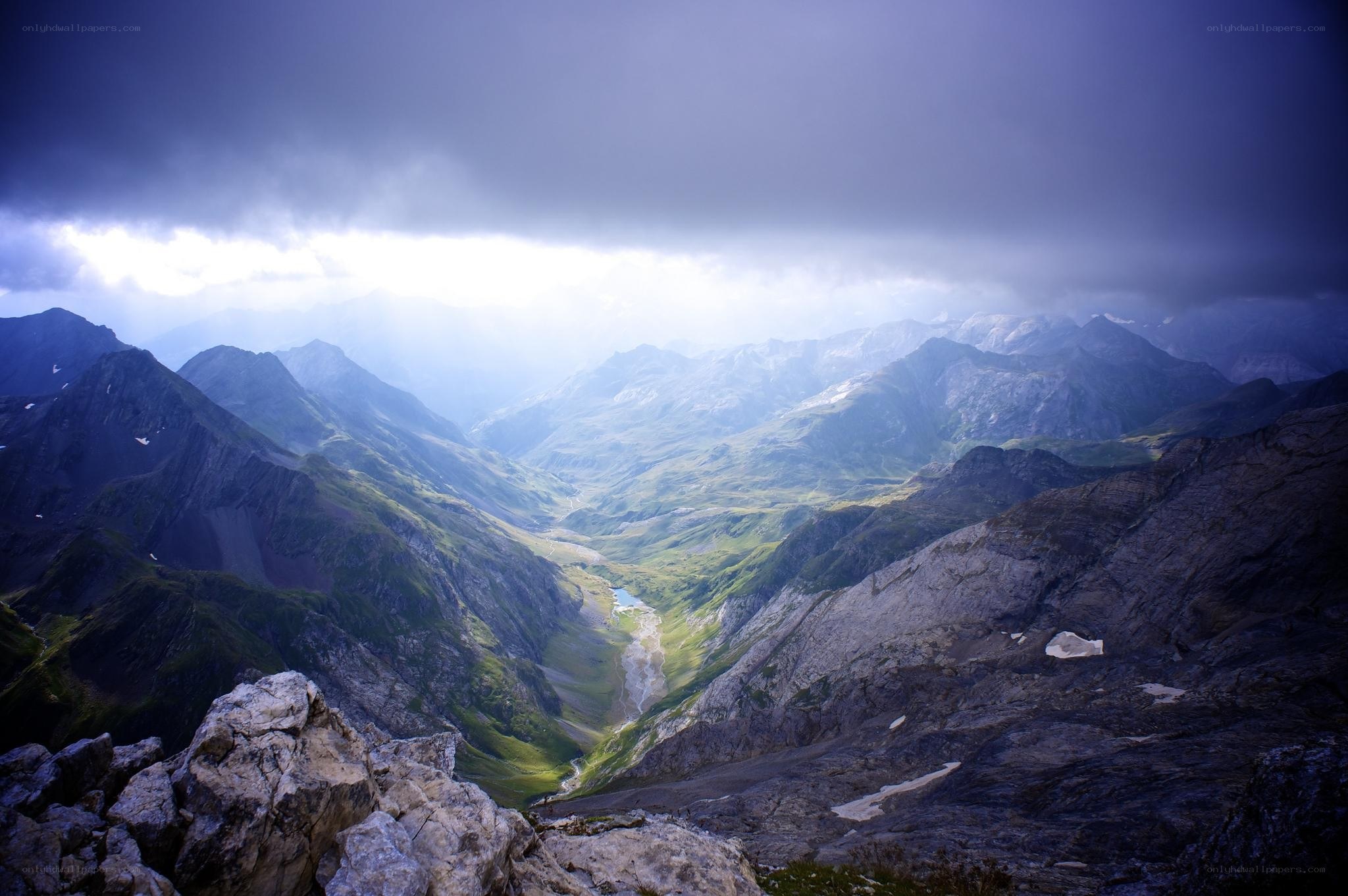 Mountain valley under stormy sky