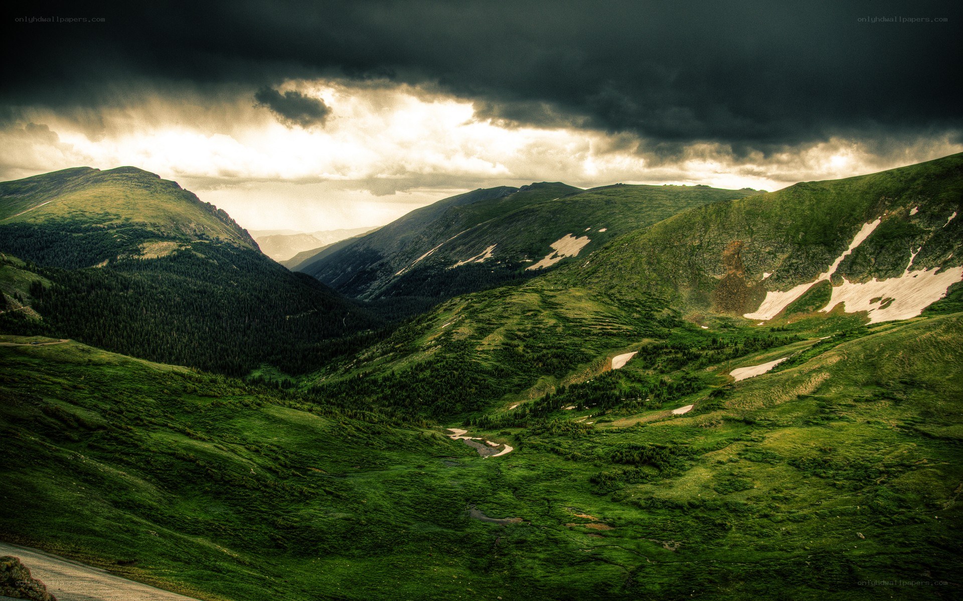 Mountain valley under stormy sky