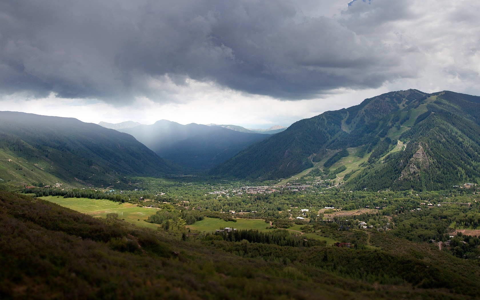 Mountain valley under stormy sky