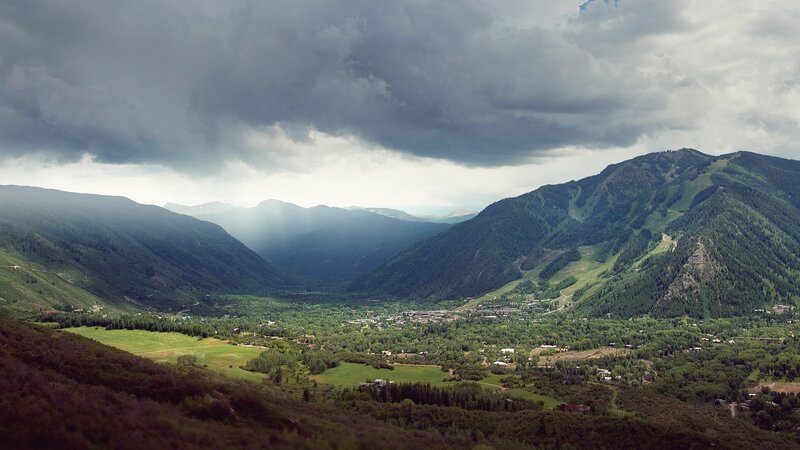mountain valley under stormy sky