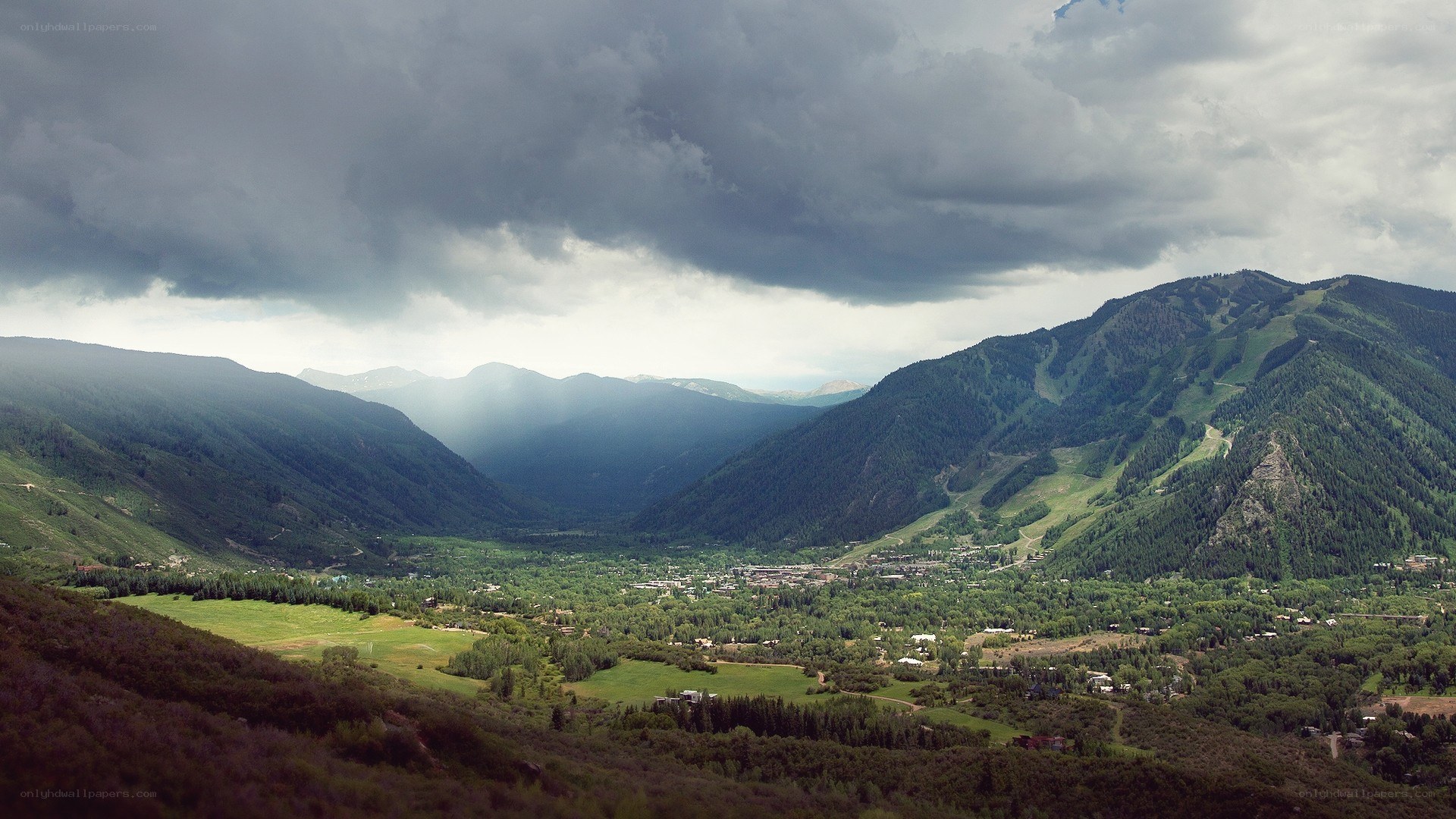 mountain valley under stormy sky