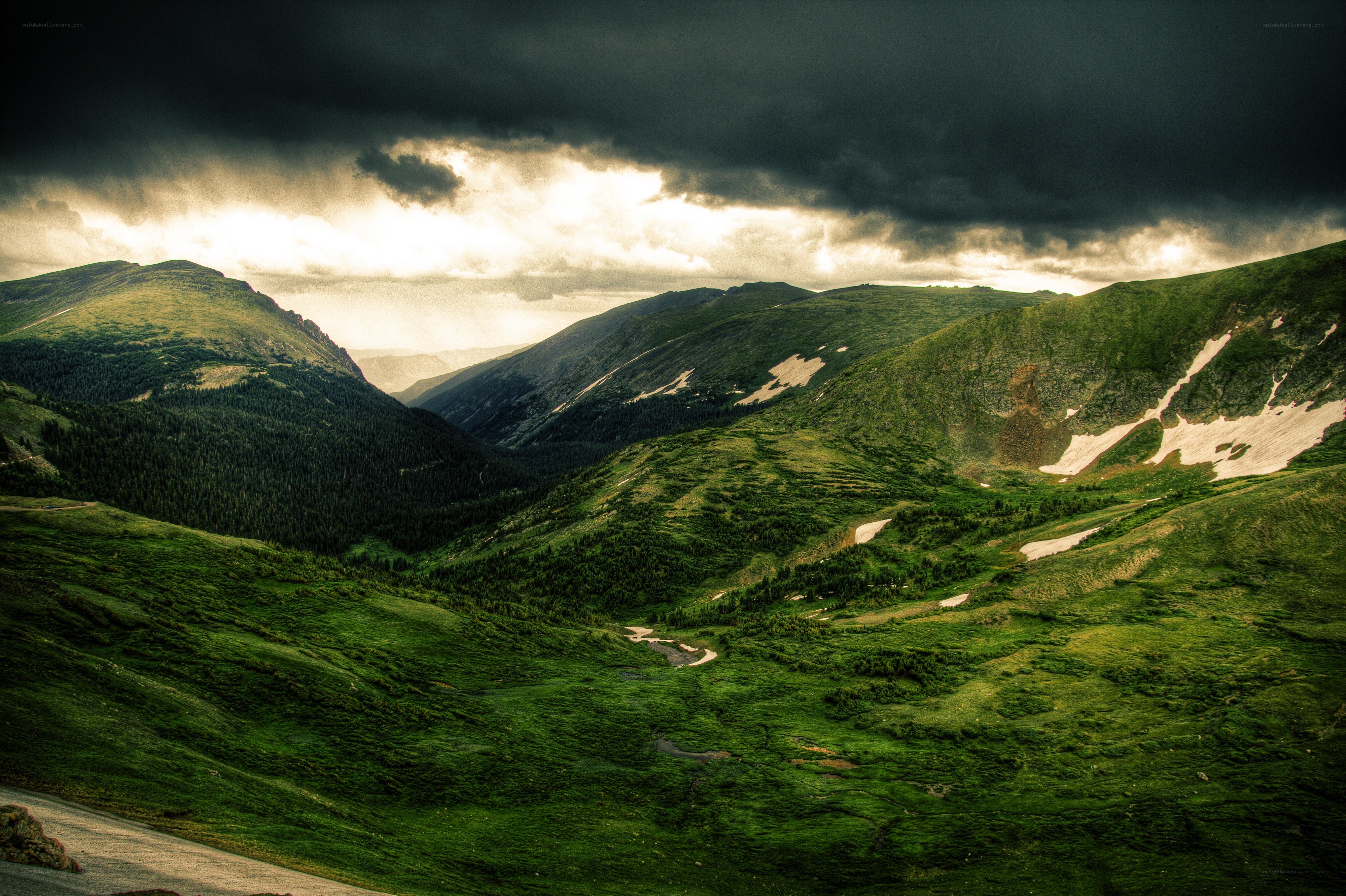 Mountain valley under stormy sky
