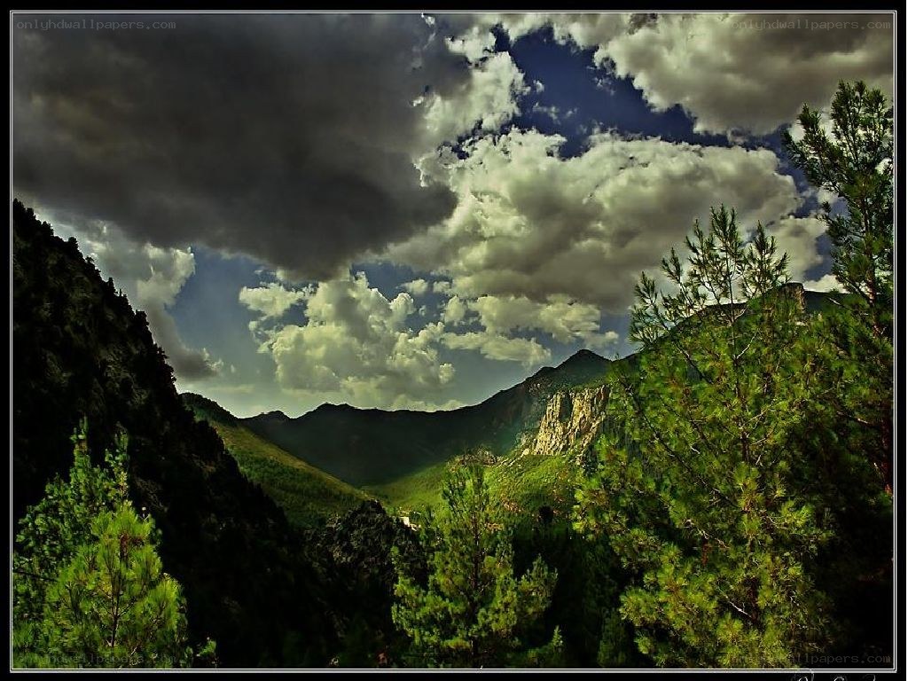 Mountain valley under stormy sky