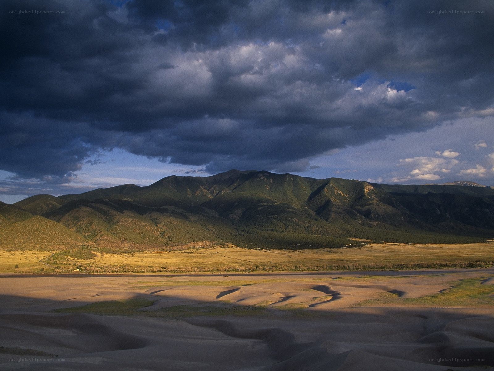 mountain valley under stormy sky