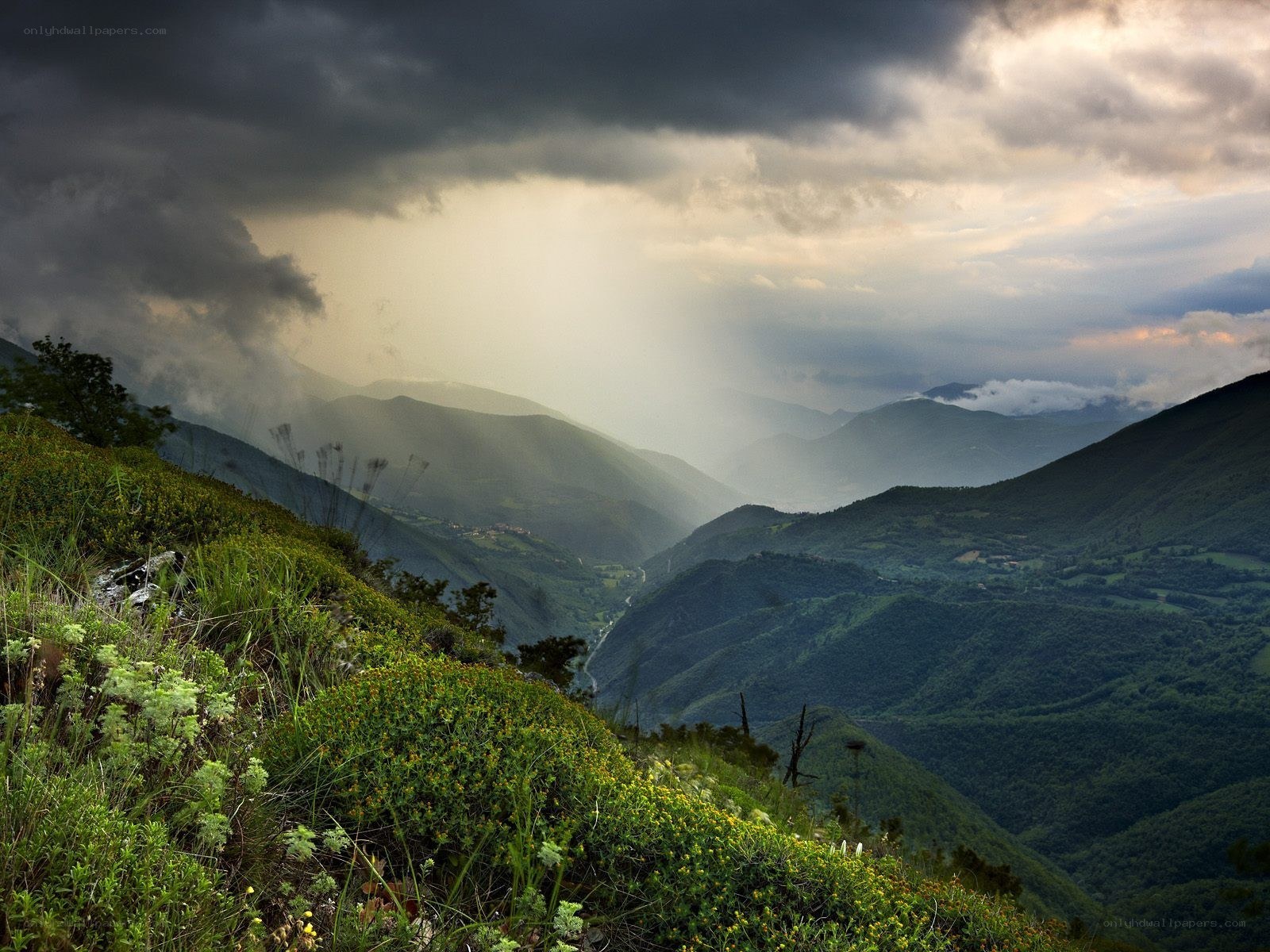 Mountain valley under stormy sky