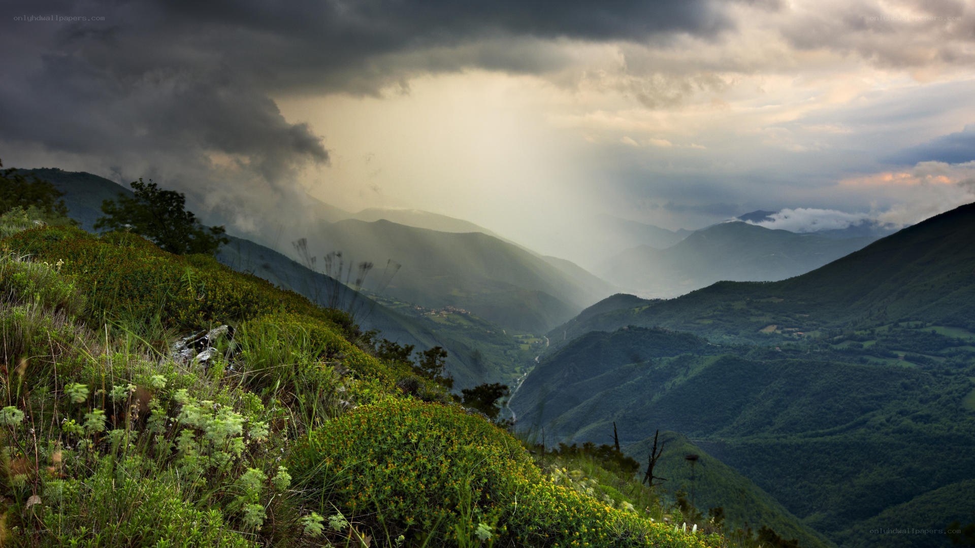 Mountain valley under stormy sky