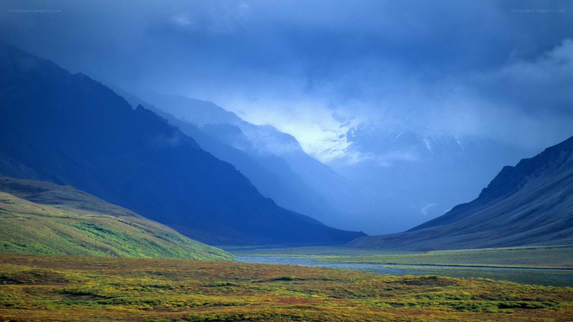 Mountain valley under stormy sky