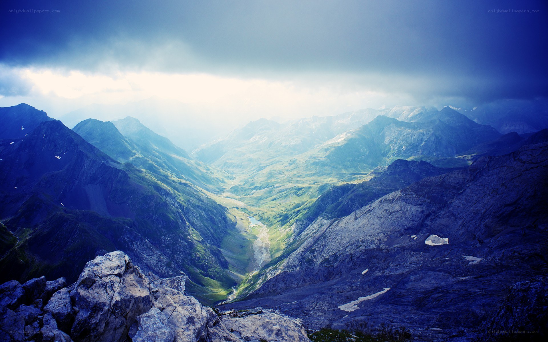 Mountain valley under stormy sky