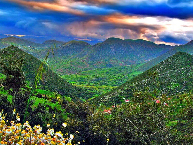Mountain valley with colorful sky