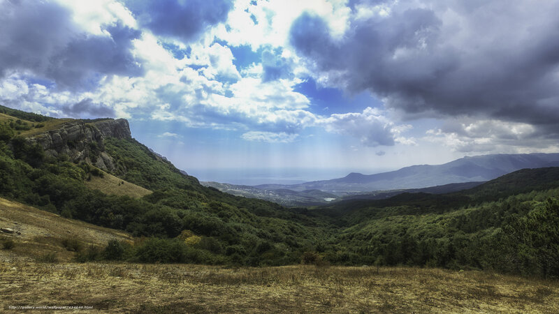 Mountain valley with dramatic sky