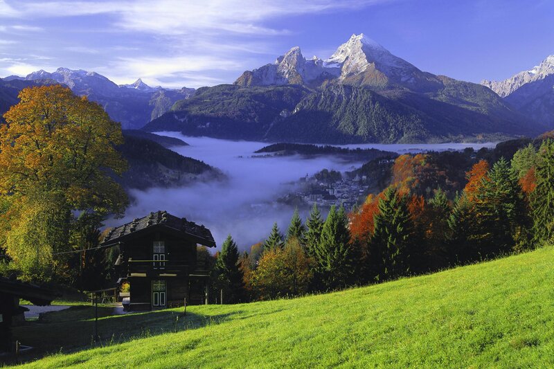 Mountain valley with fog and cabin