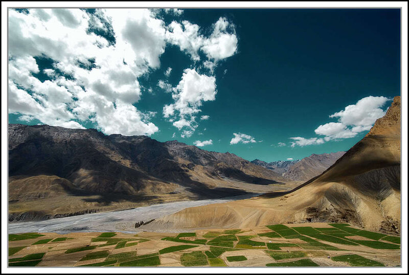 Mountain valley with green fields