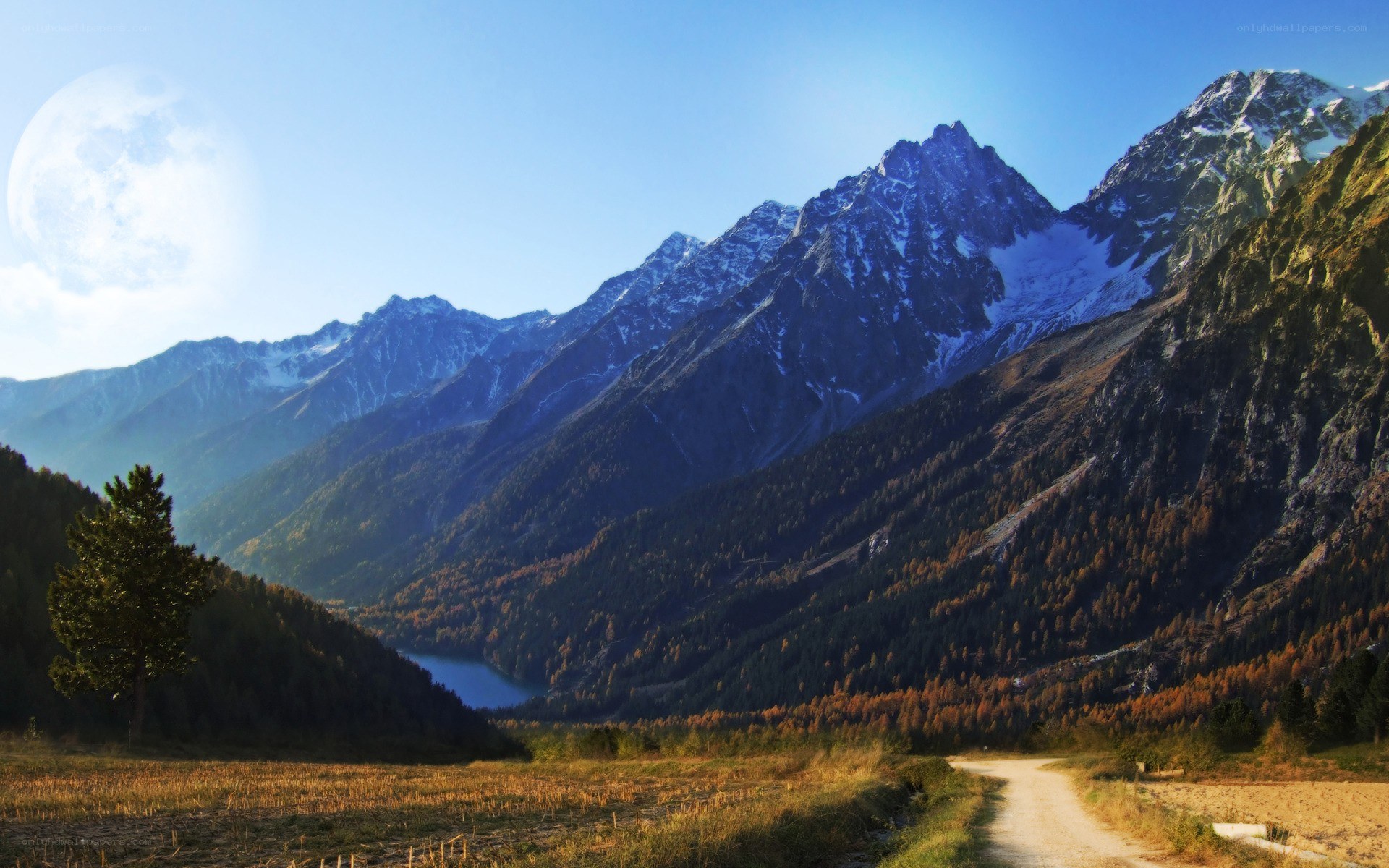Mountain valley with lake and moon