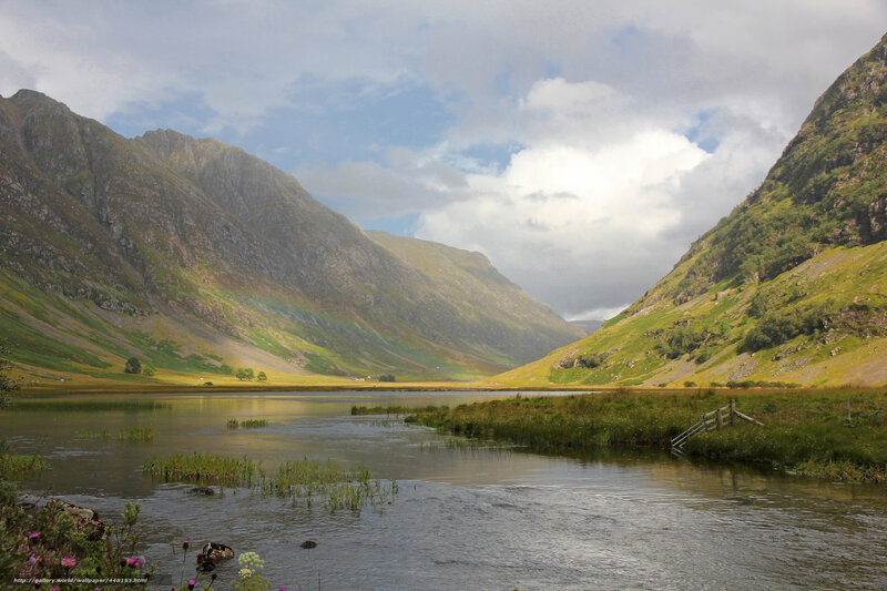 Mountain valley with lake and rainbow