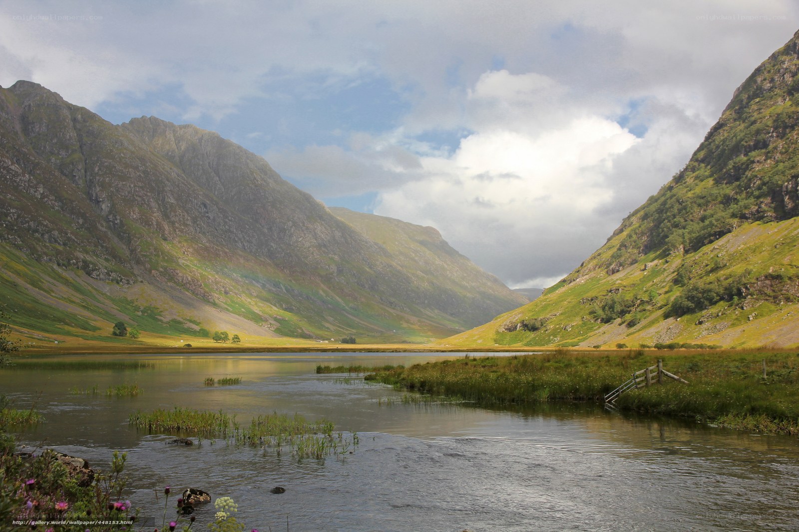 Mountain valley with lake and rainbow