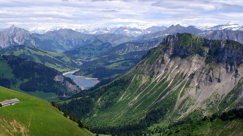 Mountain valley with lake and snow-capped peaks
