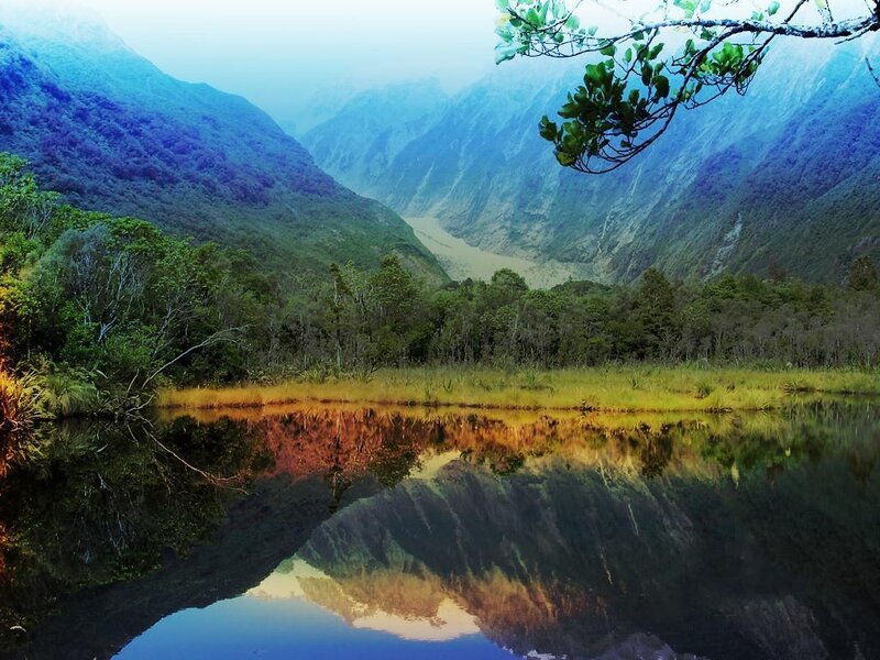 Mountain valley with lake reflection