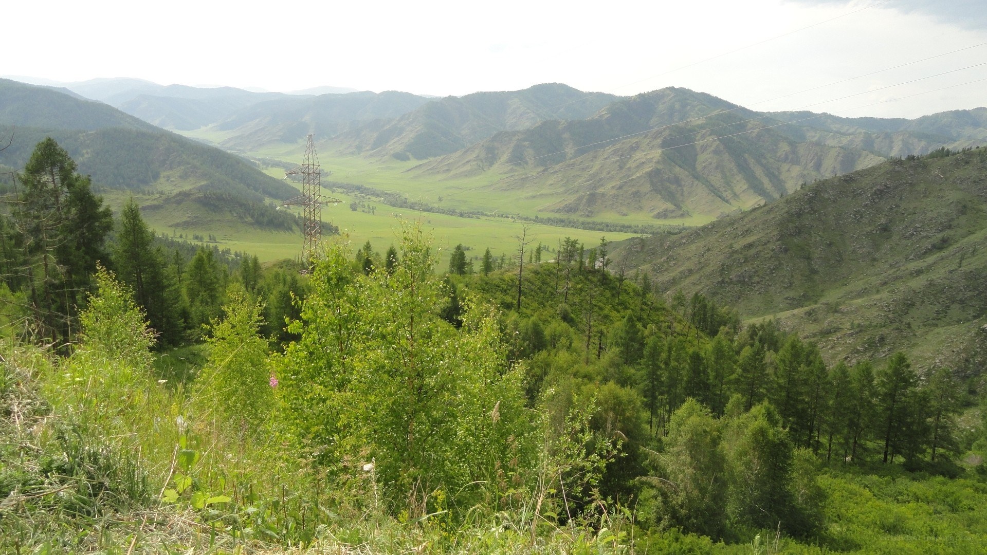 Mountain valley with power lines