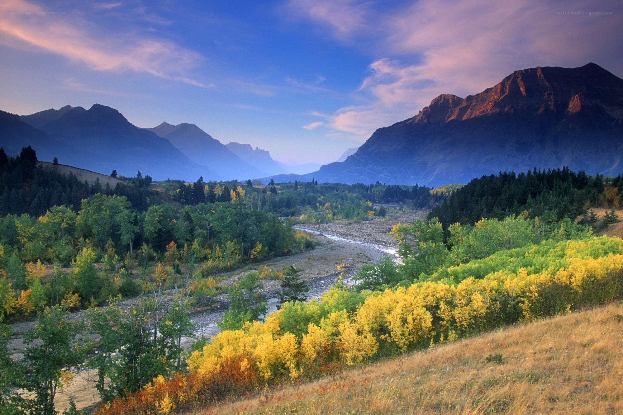 Mountain valley with river at sunset