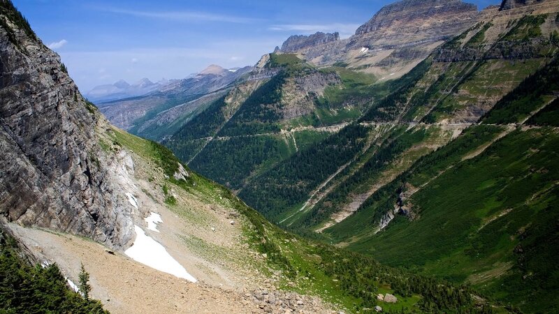 Mountain valley with snow patches