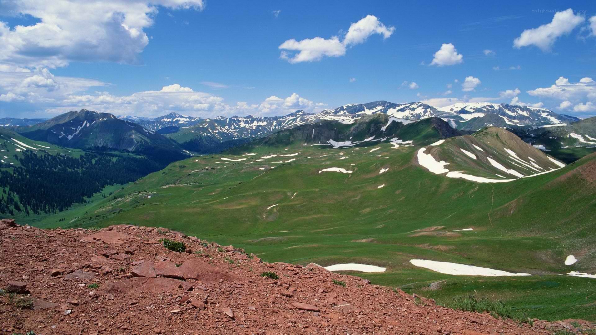 Mountain valley with snow patches