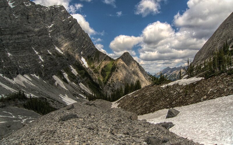 Mountain valley with snow patches