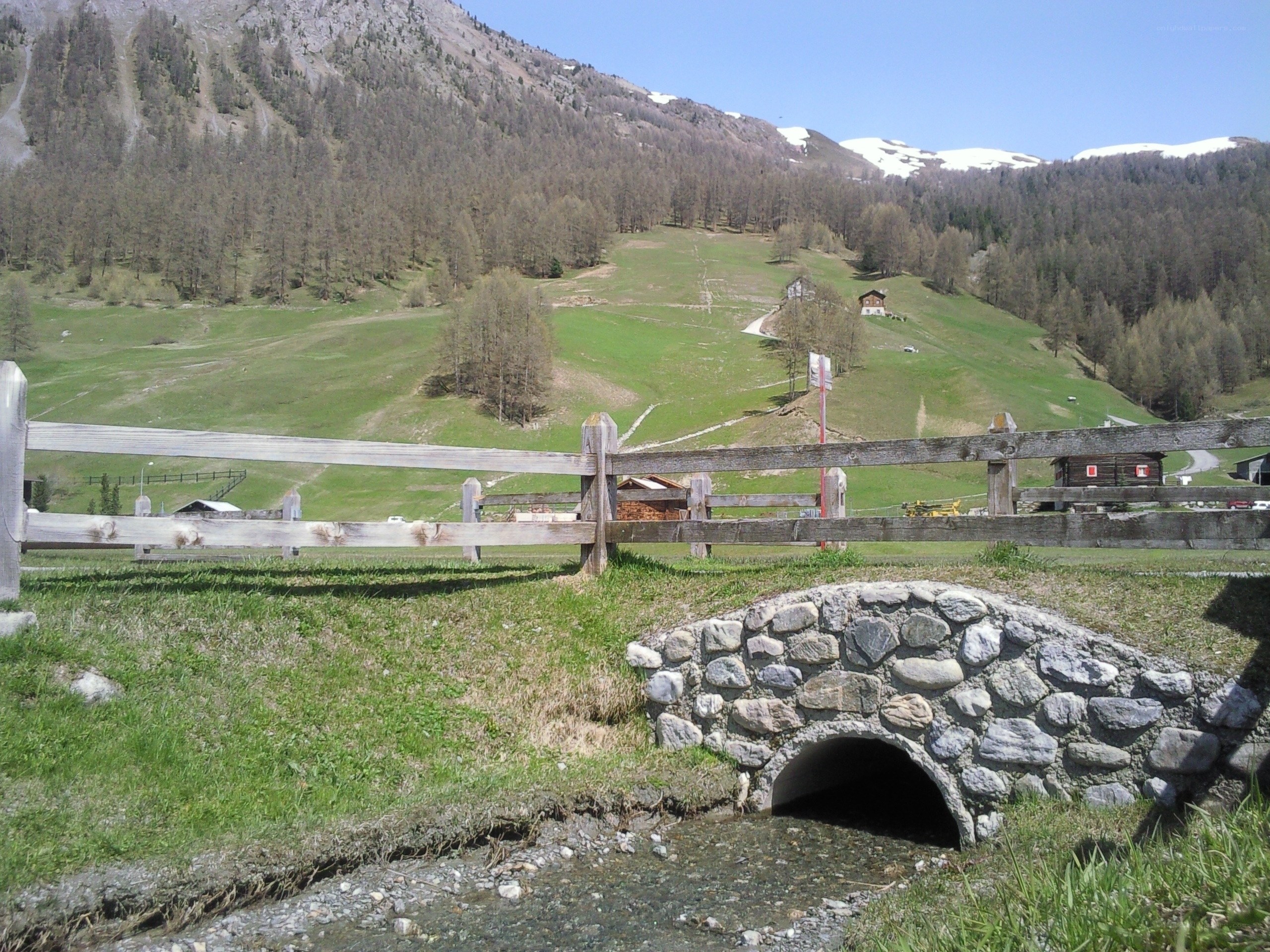 Mountain valley with stone bridge