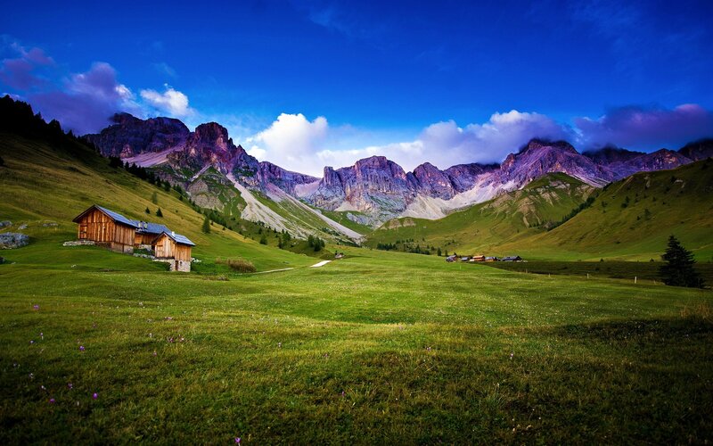 Mountain valley with wooden cabins